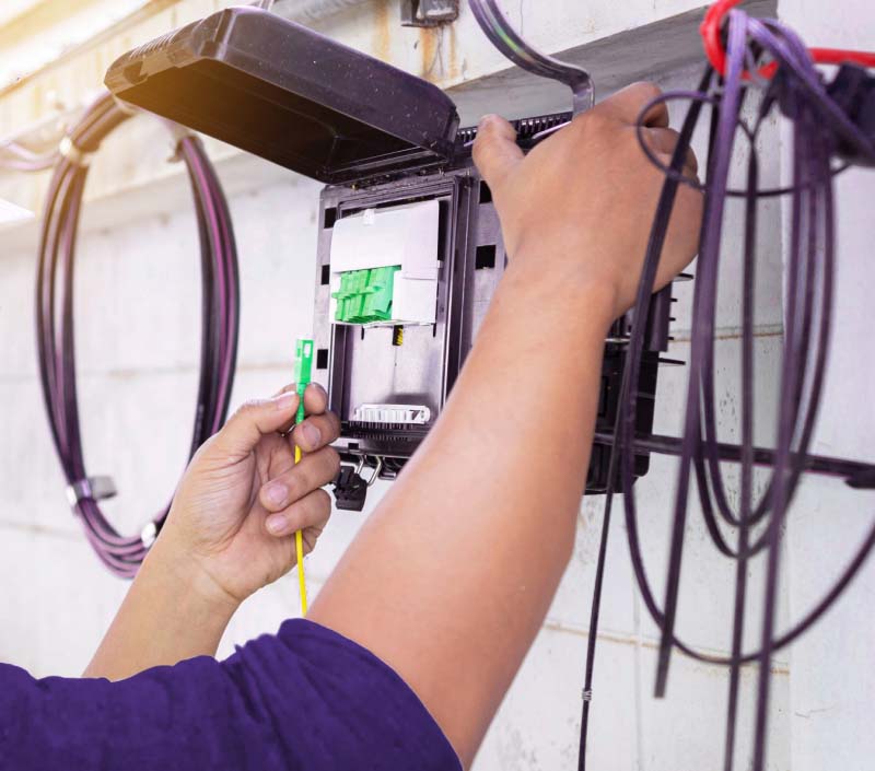 person attaching ethernet cables