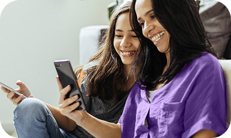 woman and daughter looking at phones