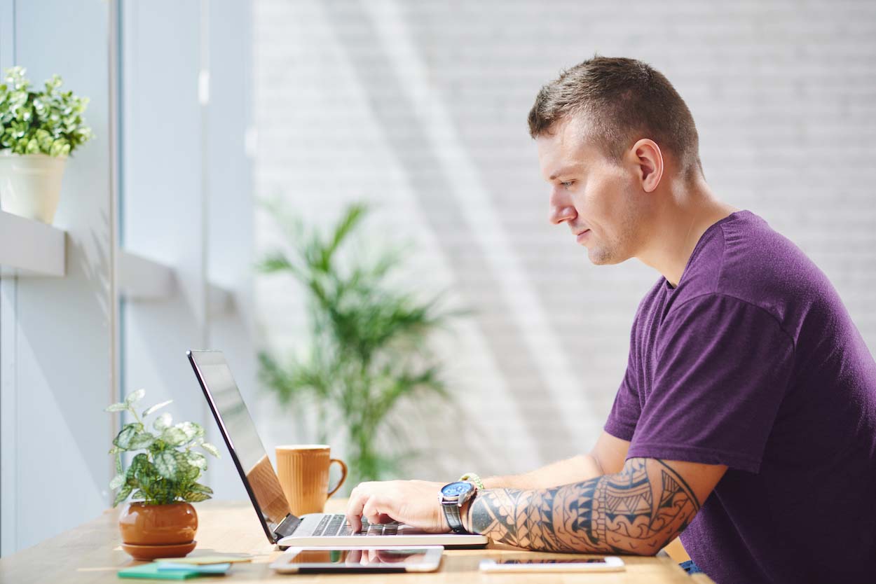 A man performing a speedtest on a laptop