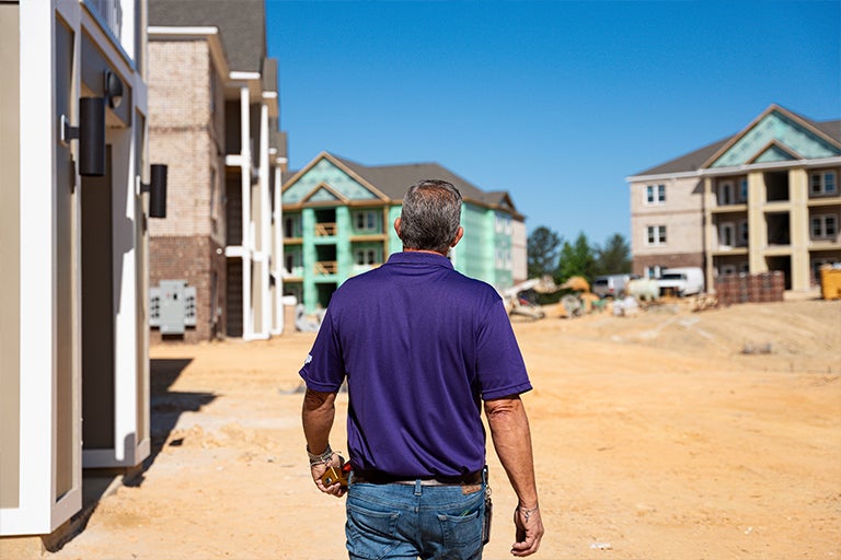 man walking construction site